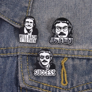 Set of three vintage black and white funny quote enamel pins on denim jacket