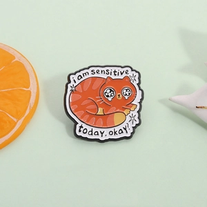 Cute orange tabby cat enamel pin with i am sensitive today text on green background