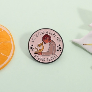 Funny scientist enamel pin with microscope and slogan on a pale green background