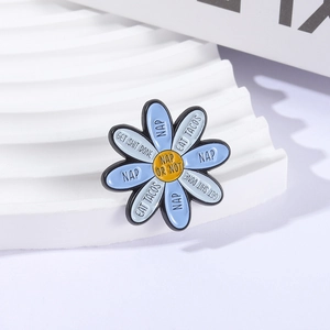 Blue daisy enamel brooch featuring Get Shit Done and Nap Or Not creative lettering
