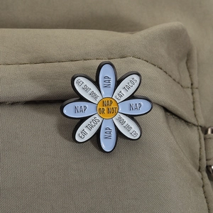 Daisy enamel brooch with blue and white petals and funny quotes on green canvas