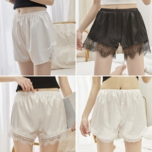 Detailed view of satin sleep shorts with delicate lace trim and side bow accents