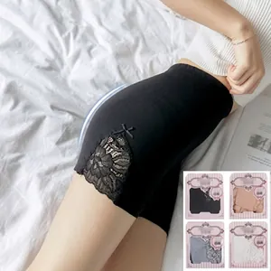 Detail of high waist shaping shorts with black lace trim and small bow accent on the side