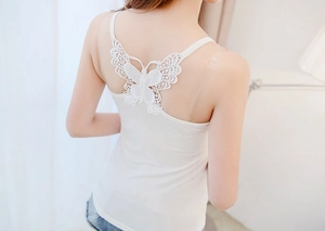 Detailed view of white camisole featuring intricate lace butterfly embroidery on back