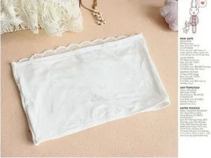 Close-up of modal lace tube top showing delicate white floral embroidery and elastic fabric