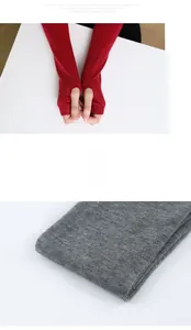 Detail of red and grey knitted fingerless arm warmers with thumb holes and soft texture