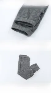 Detailed view of dark grey knitted fingerless gloves showing rib knit texture and cuff stitching