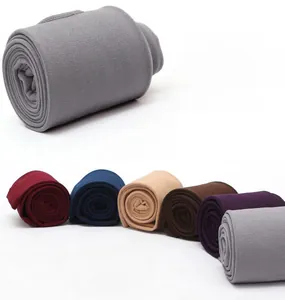 Detail showing various colors of thermal leggings with high-quality knit texture for winter