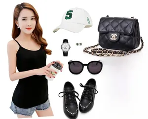 Flat lay of black modal tube top with bow tie back styled with denim shorts and accessories