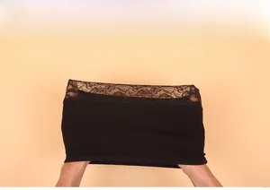 Elasticity test showing a black modal tube top with floral lace trim being stretched
