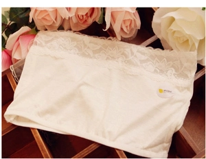 Detail of white modal strapless bandeau bra with wide floral lace trim and soft texture