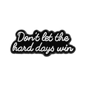 Black and white enamel pin with inspirational quote Don't let the hard days win