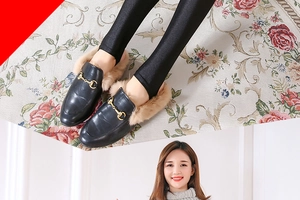 Detail of black satin leggings paired with horsebit loafers and faux fur lining