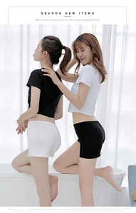 Women's black and white high-elastic anti-chafing safety shorts in a cozy home setting