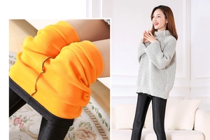 Detail of warm orange fleece lining and black elastic fabric for winter leggings