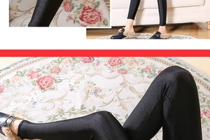 Close-up of black glossy leggings with metallic sheen paired with velvet mule shoes