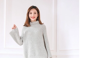 Detailed view of high neck grey knit sweater featuring stylish flared bell sleeves