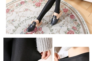 Detail showing elastic stirrup design and glossy shiny fabric of black slim leggings