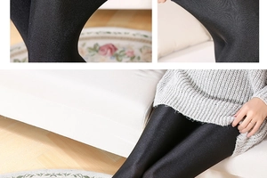 Detailed view of high-gloss black leggings featuring silky texture and slim-fit high waist design