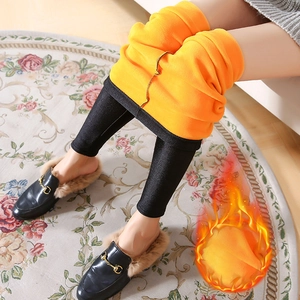 High-waisted glossy black thermal leggings with thick orange fleece lining for winter warmth