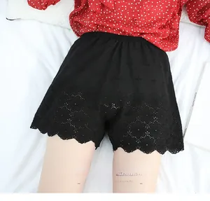 Detailed close-up of high-waisted black cotton safety shorts with hollow floral lace trim
