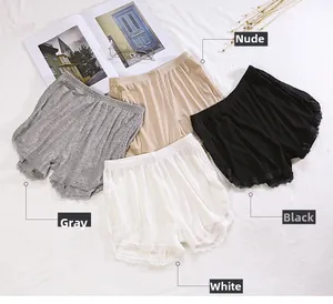 Flat lay of four lace-trim safety shorts in grey, beige, black, and white colors