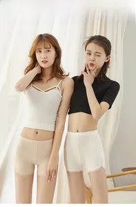 Detail shot of high-waist safety shorts featuring delicate white lace trim and elastic fabric
