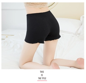 Close-up of black ribbed safety shorts featuring ruffled hems and elastic waistband