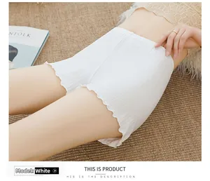 Detailed macro view of white pleated safety shorts with elastic waist and ruffled edges