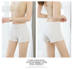Detail of white safety shorts showing elastic ribbed fabric and decorative ruffled edges