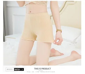 Detailed view of beige ribbed safety shorts for women with elastic lettuce edge trim