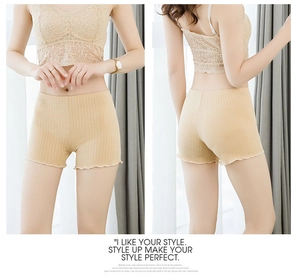 Close-up of ribbed texture and lettuce edge detail on beige safety shorts for women