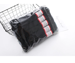 Detail view of bundled black velvet socks in transparent packaging for spring and summer