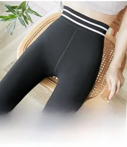 Detail of high waist thermal leggings with white stripe waist design and ribbed texture