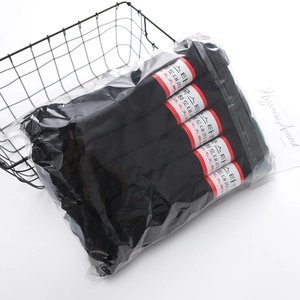 Multipack of black velvet cotton socks for women with red labels in a black wire basket