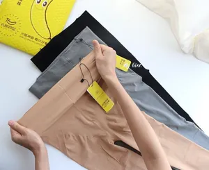 Detailed texture showing elastic tights in nude, grey and black with reinforced waistband