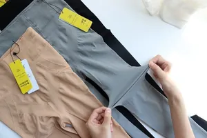 Close-up of high-stretch seamless leggings showing fabric elasticity and nude color