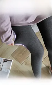 Detail of high-stretch dark grey thermal leggings showing 360-degree flexibility