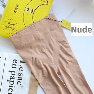 Detailed view of nude compression tights featuring diamond-pattern tummy control weave