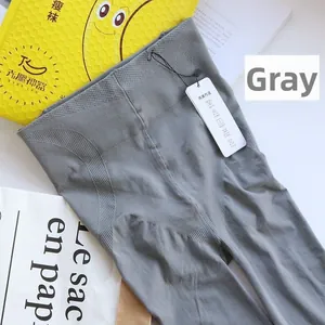Detail of grey shaping tights featuring a wide ribbed waistband for tummy control effect