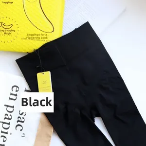 Detail view of black high-waist slimming leggings with dense knit texture and packaging