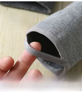 Detail view of charcoal grey thermal leggings featuring elastic stirrup design for women