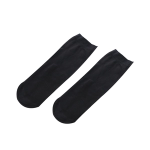 Pair of ultra-thin semi-transparent black velvet crew socks for women on white background
