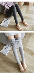 Close-up of high-waist thermal leggings showing compression fabric and stirrup design details