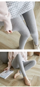 Detail of high-elastic grey thermal stirrup leggings showing thick warm knit texture