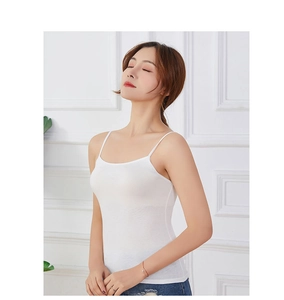 Close-up of a white modal camisole with thin straps and a slim fit on a model