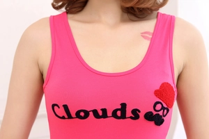 Detail of pink cotton tank top featuring Clouds embroidery and whimsical graphic patch