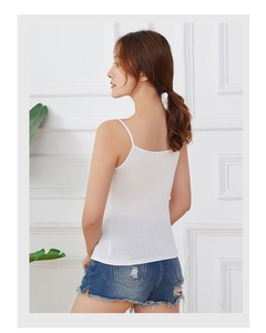 Minimalist white modal camisole with thin straps paired with denim shorts for summer