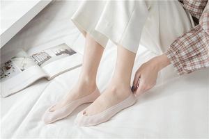 Close-up of seamless light pink invisible boat socks with non-slip silicone grip for women