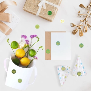 Green and cream Thank You sealing stickers shown on gift boxes and envelopes